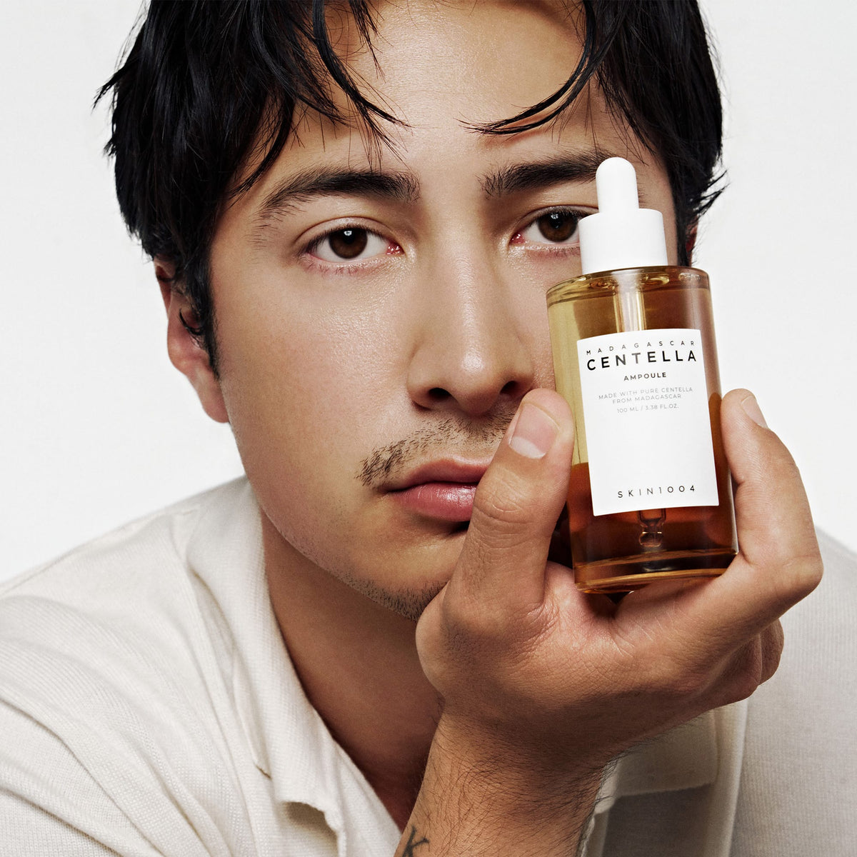 Model holding SKIN1004 Madagascar Centella Ampoule 100 ml — manufacturer photograph