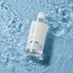 ROUND LAB 1025 Dokdo Cleansing Water bottle floating at an angle in blue water — manufacturer photograph