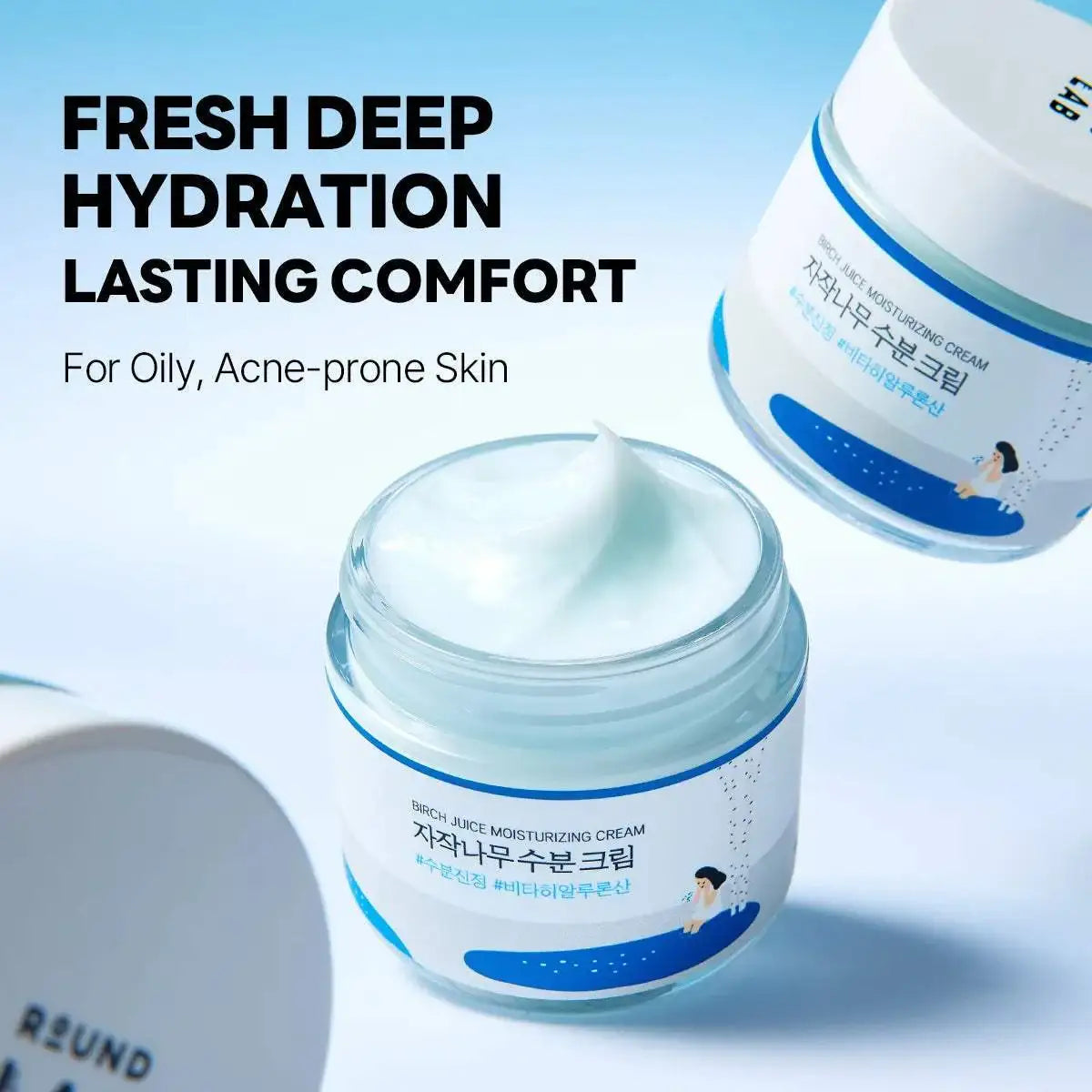 ROUND LAB Birch Juice Moisturizing Cream open jar showing its cream texture beside a closed jar on a blue background — manufacturer image